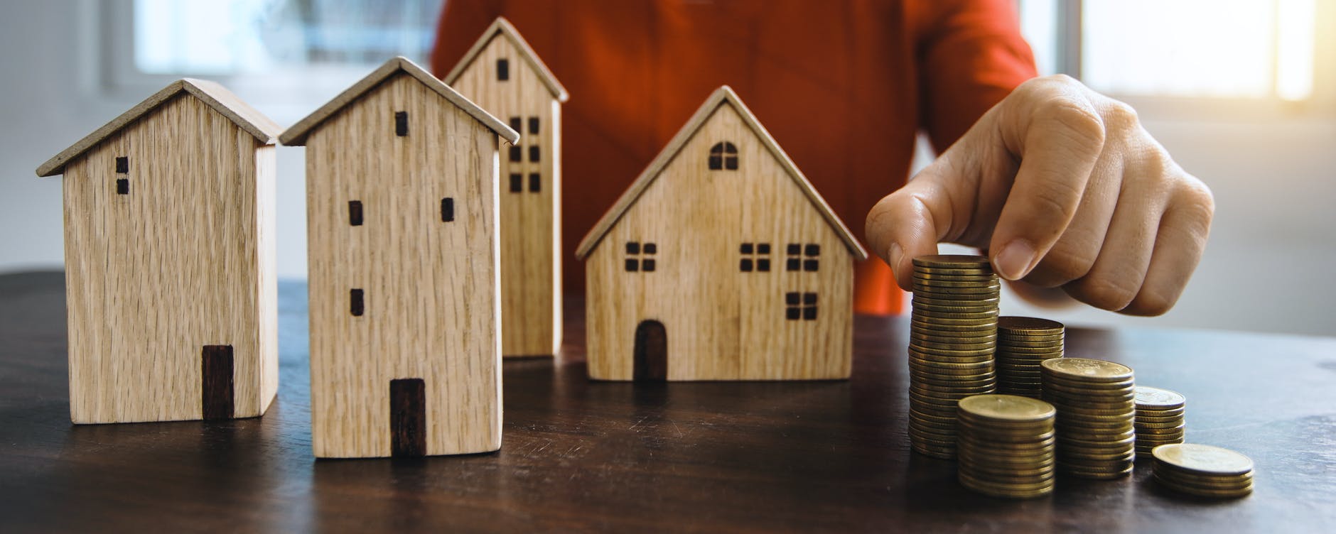 Photo by Khwanchai Phanthong from Pexels Person saving money for a house